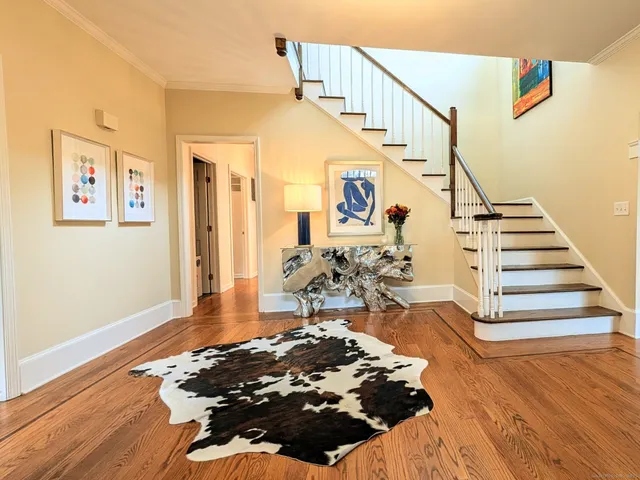 a view of entryway livingroom and hall with wooden floor