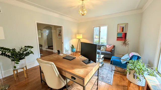 a view of a dining room with furniture window and wooden floor