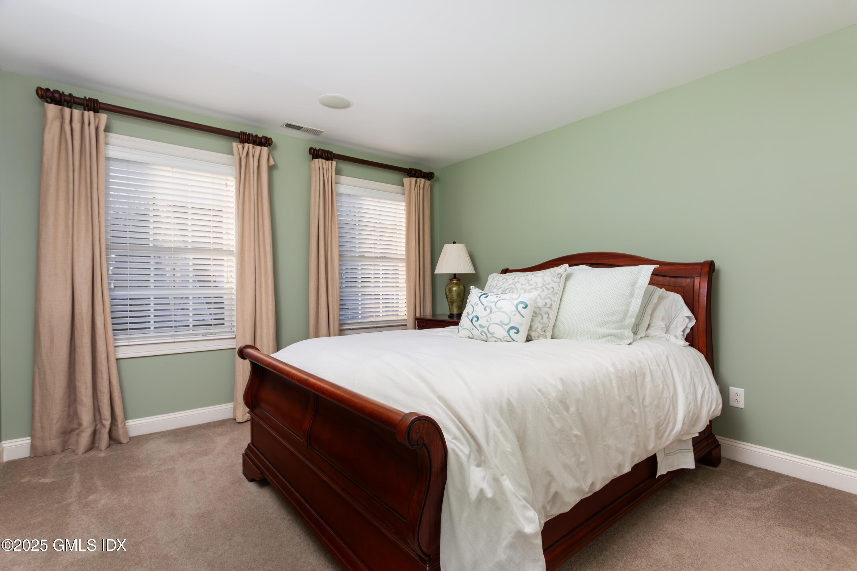 105 Hamilton Avenue, Unit 9 Greenwich, CT 06830 - Photo 14 of 20 a bed sitting in a bedroom next to a window