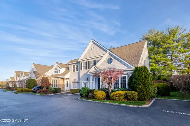 a front view of a house with a yard and outdoor seating