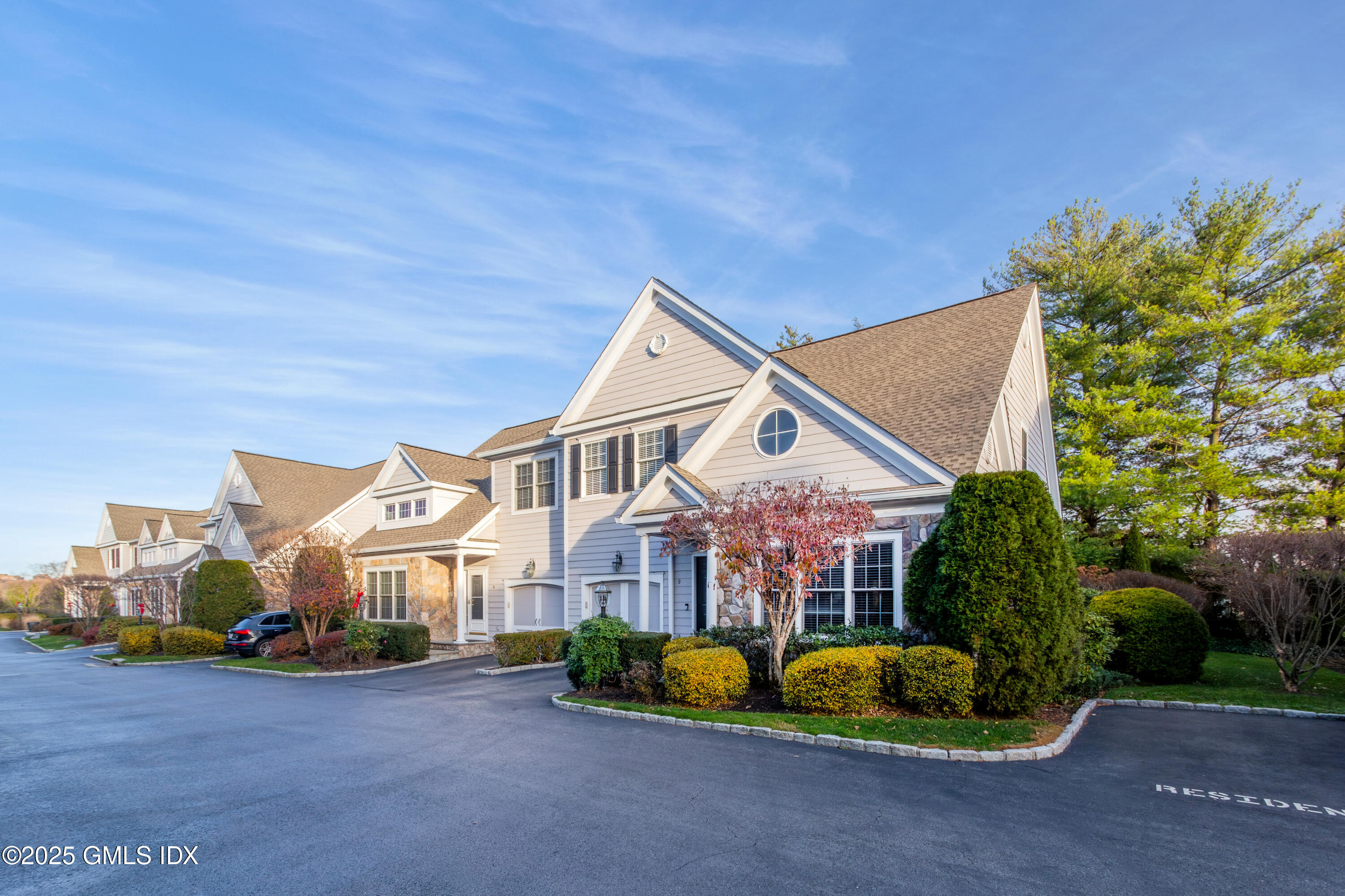 105 Hamilton Avenue, Unit 9 Greenwich, CT 06830 - Photo 2 of 20 a front view of a house with a yard and outdoor seating