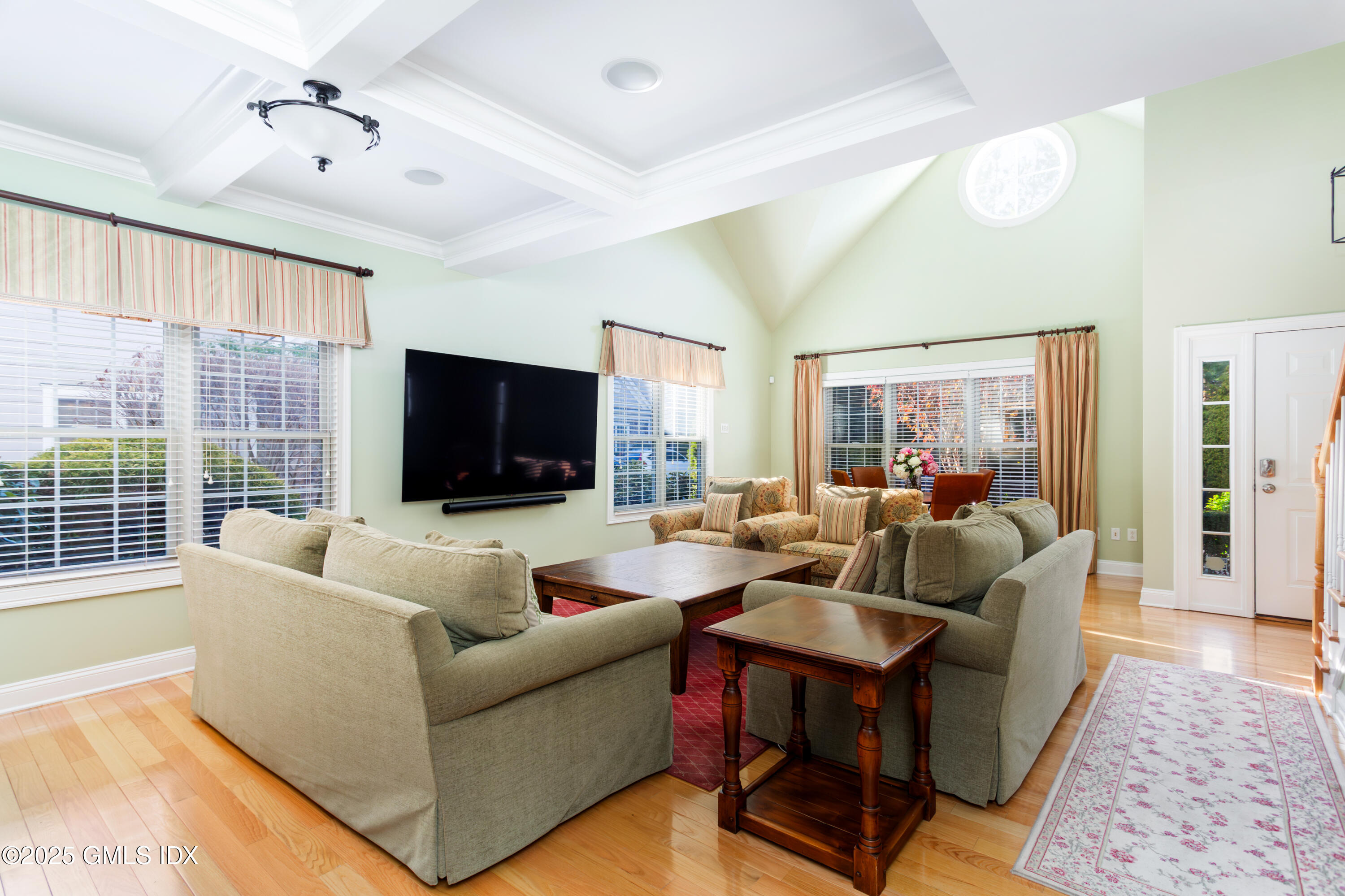 105 Hamilton Avenue, Unit 9 Greenwich, CT 06830 - Photo 3 of 20 a living room with furniture a flat screen tv and a large window