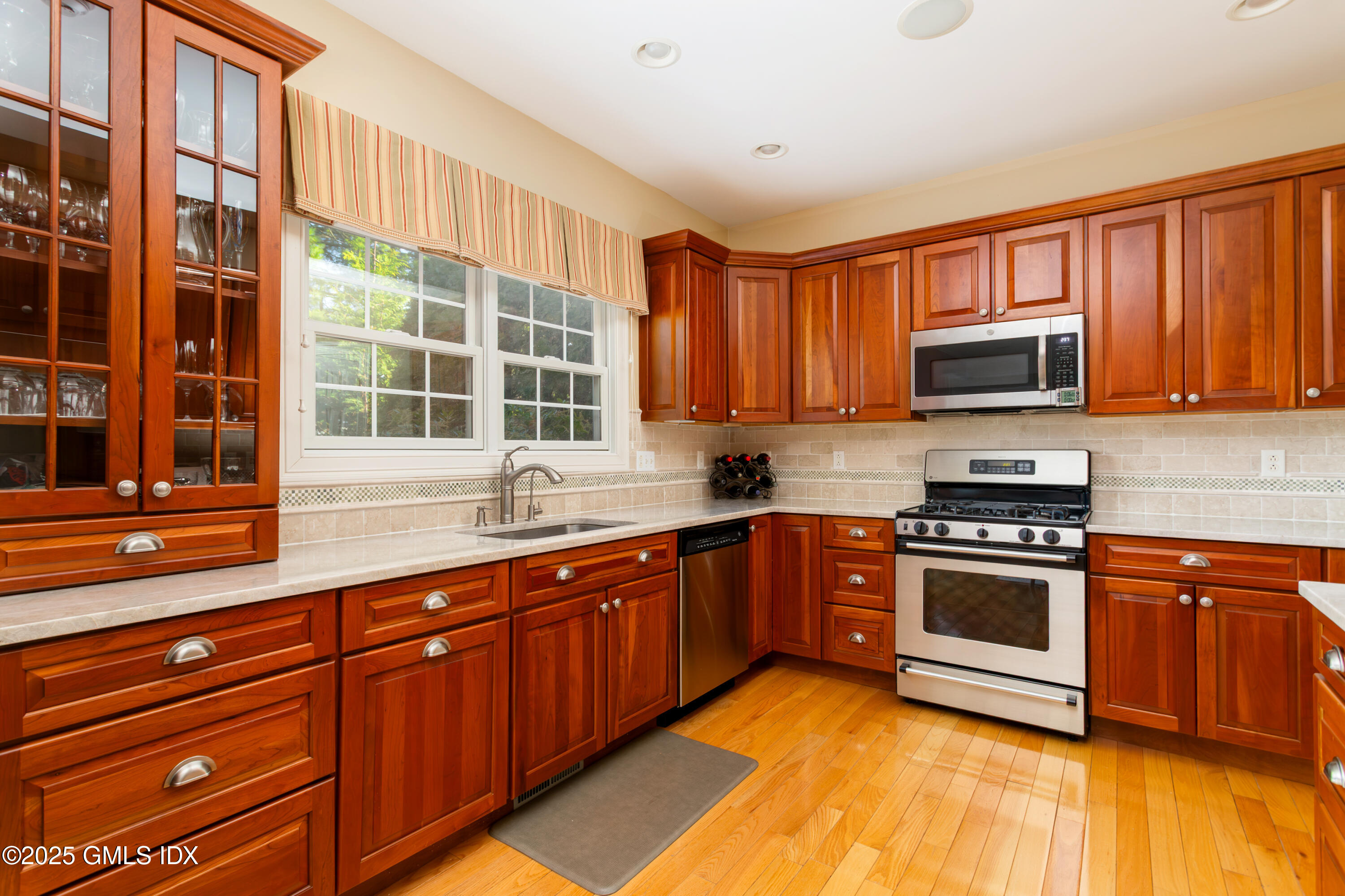 105 Hamilton Avenue, Unit 9 Greenwich, CT 06830 - Photo 8 of 20 a kitchen with stainless steel appliances granite countertop a stove sink and cabinets