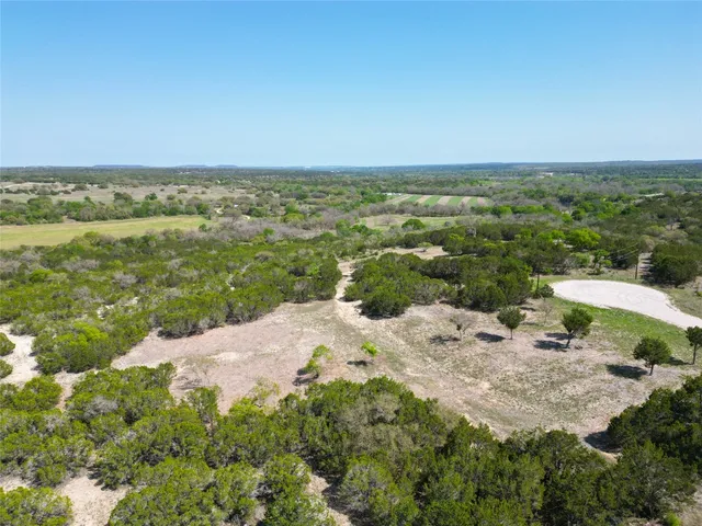 a view of a lake with beach and city