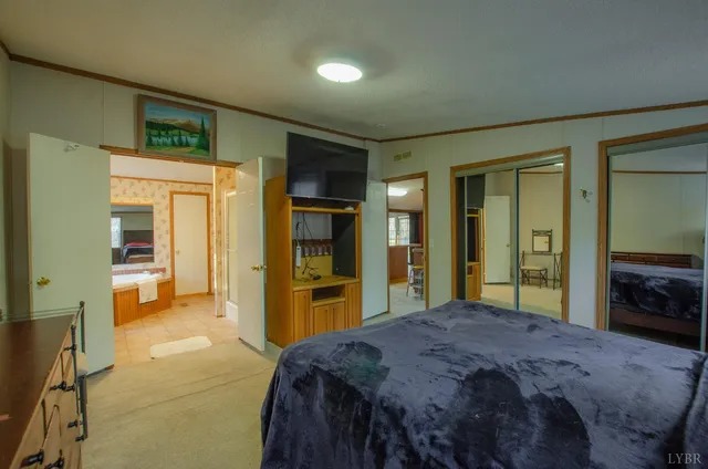 a bedroom with a bed and a large mirror