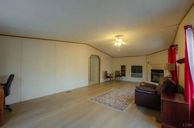 a living room with furniture rug and a window
