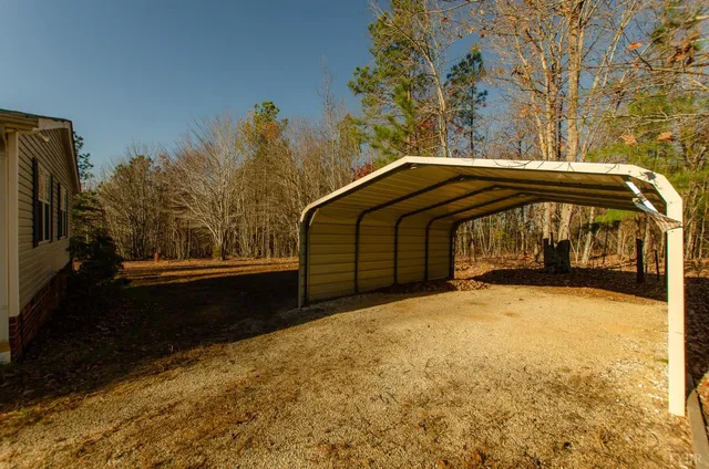 a balcony with wooden floor and bench