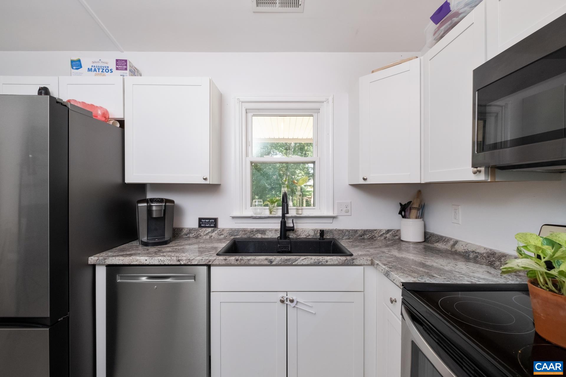 71 Azalea Road Ruckersville, VA 22968 - Photo 11 of 23 a kitchen with granite countertop a sink stove and refrigerator