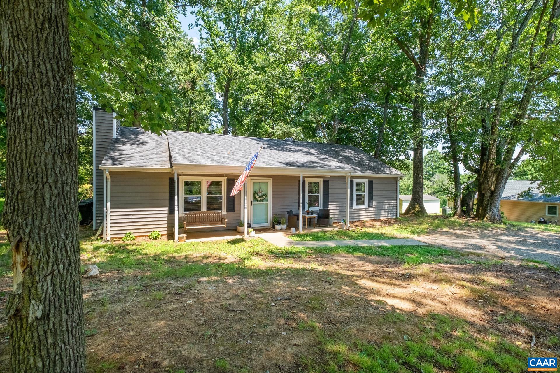 71 Azalea Road Ruckersville, VA 22968 - Photo 3 of 23 a front view of a house with a garden and trees