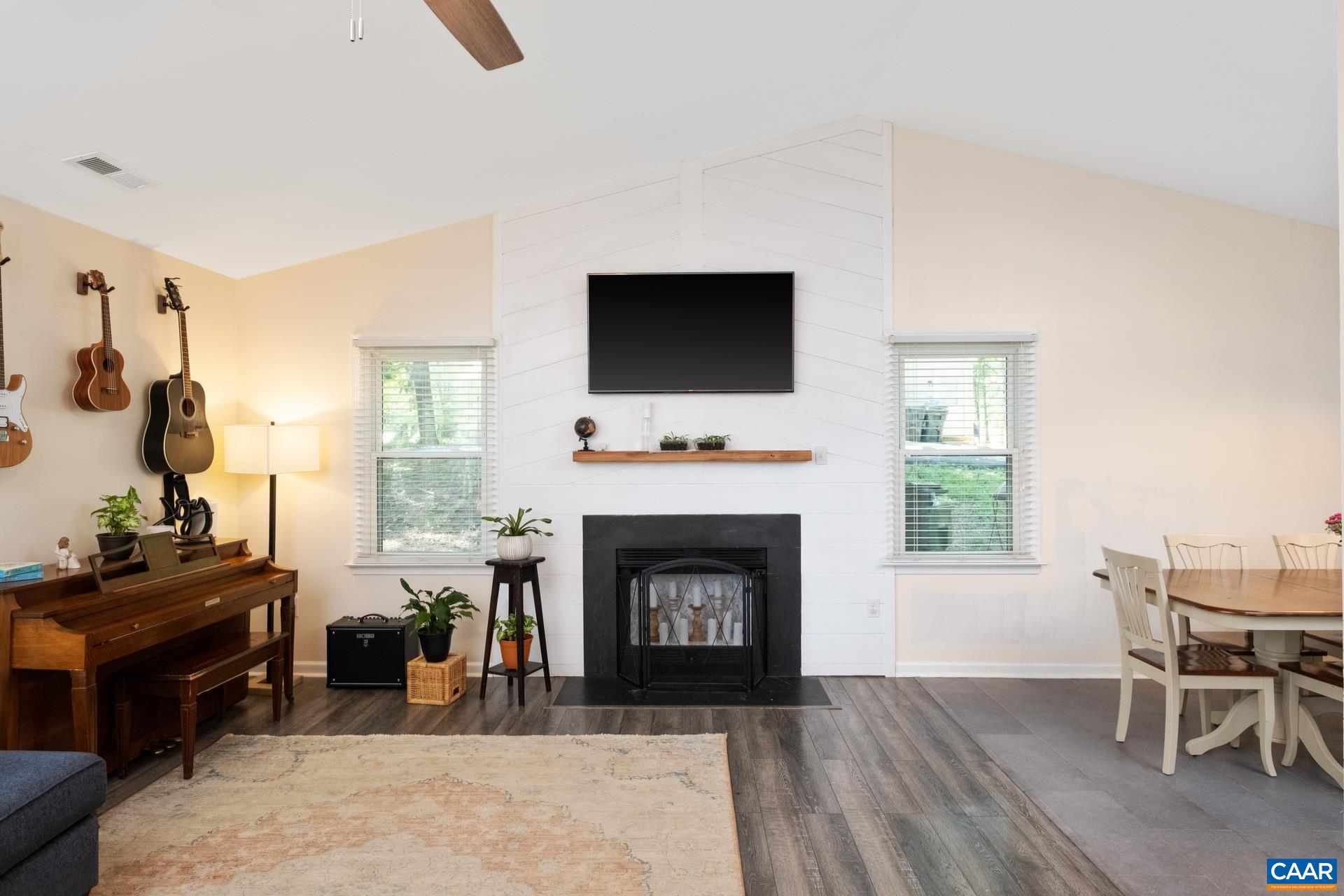 71 Azalea Road Ruckersville, VA 22968 - Photo 5 of 23 a living room with furniture a fireplace and a flat screen tv