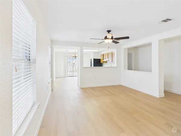 a view of a kitchen with a sink and a ceiling fan
