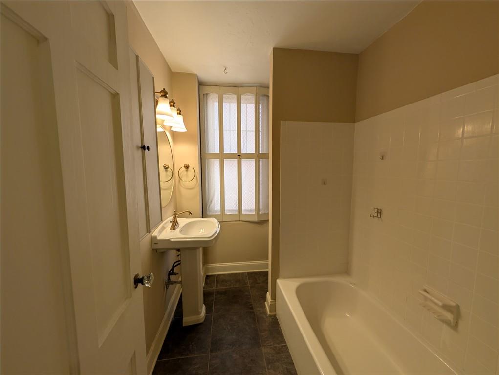 144 North Dithridge Street, Unit 403 Pittsburgh, PA 15213 - Photo 14 of 31 a bathroom with a sink a toilet and shower