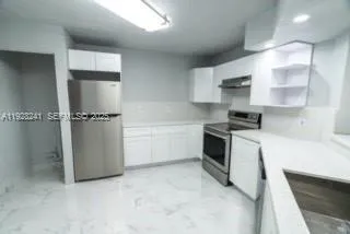 a kitchen with cabinets and a stove top oven