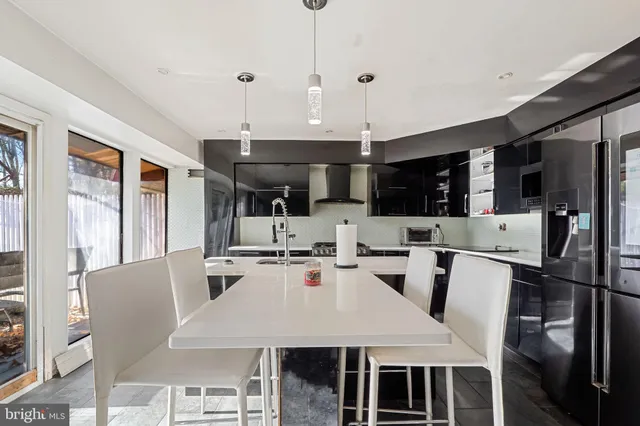 a dinning room and kitchen with a table chairs a workspace