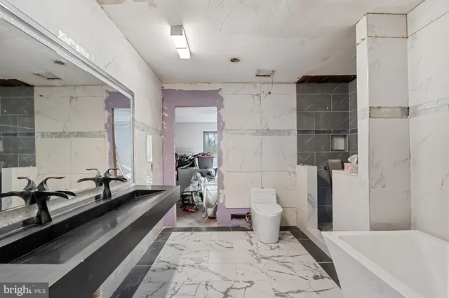 a spacious bathroom with a bathtub and toilet