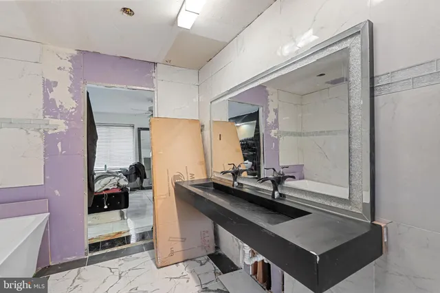 a room with a table chairs and white walls