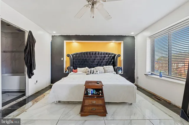 a bedroom with a bed and a flat tv screen