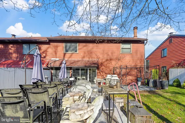 a view of a patio with table and chairs with wooden floor and fence