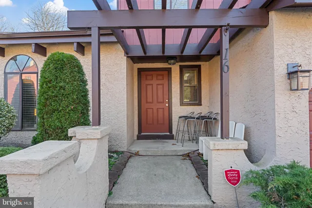 a front view of a house with an outdoor seating