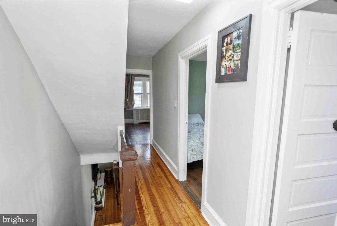 914 Township Line Road Elkins Park, PA 19027 - Photo 12 of 22 a view of a hallway with wooden floor and staircase