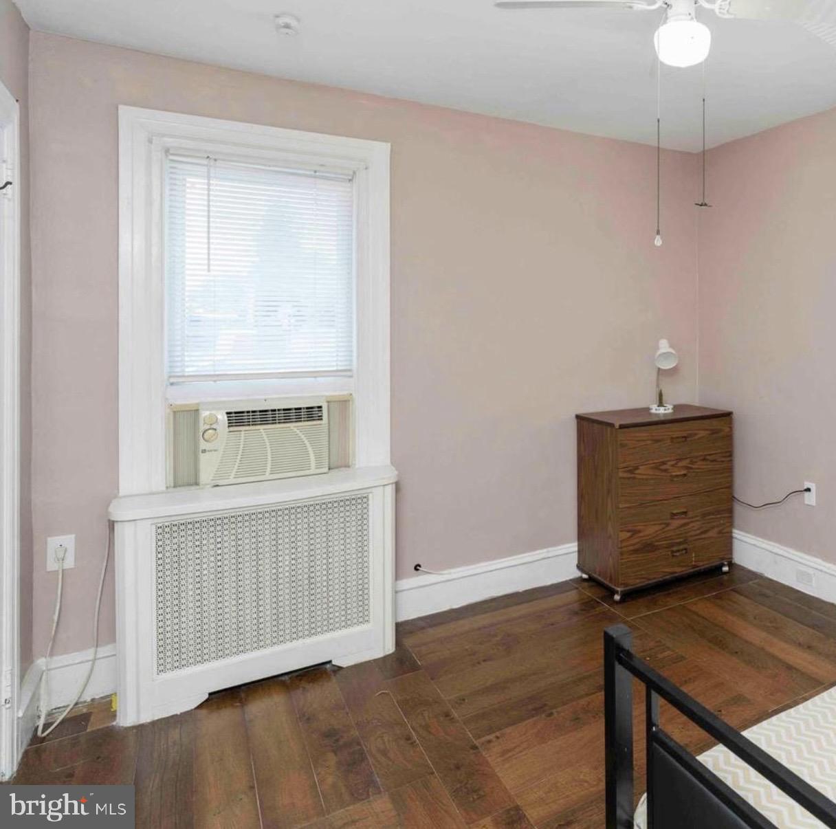 914 Township Line Road Elkins Park, PA 19027 - Photo 19 of 22 a view of an empty room with wooden floor and a window