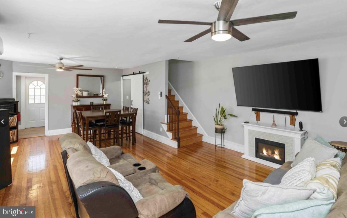 914 Township Line Road Elkins Park, PA 19027 - Photo 5 of 22 a living room with furniture a flat screen tv and a fireplace