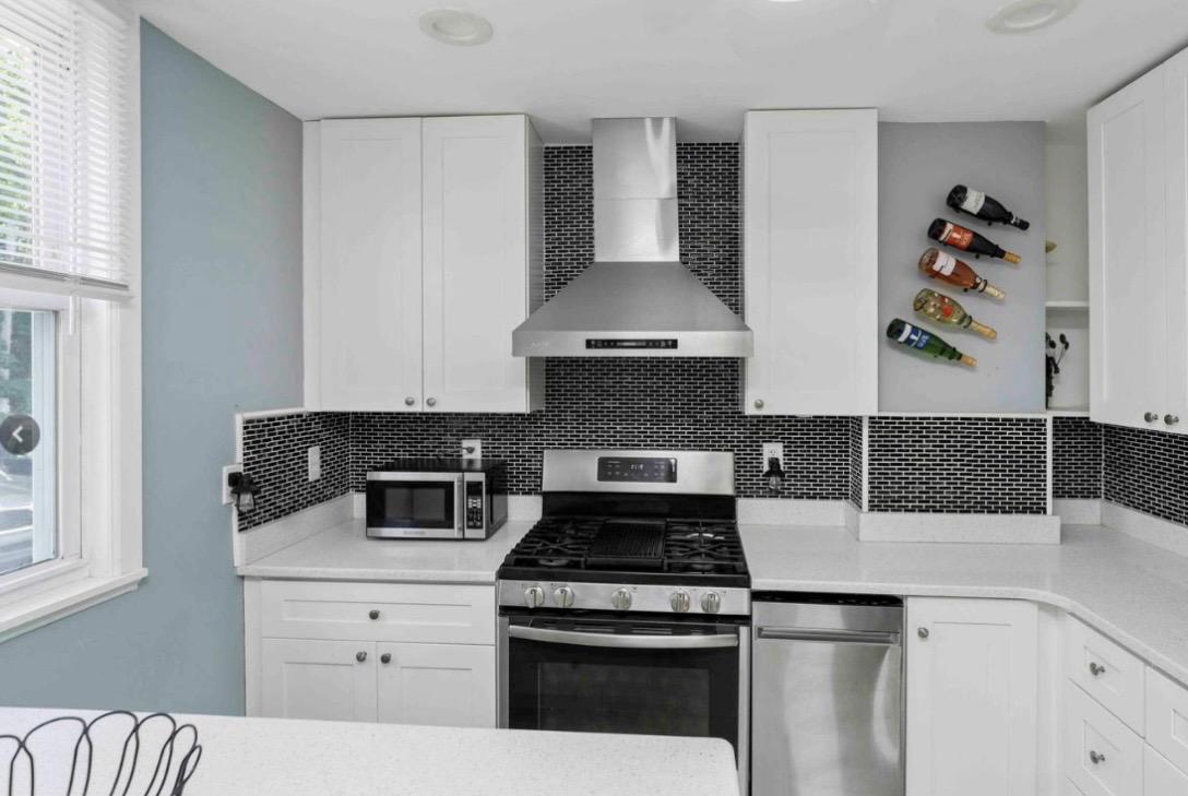 914 Township Line Road Elkins Park, PA 19027 - Photo 8 of 22 a kitchen with a stove and white cabinets