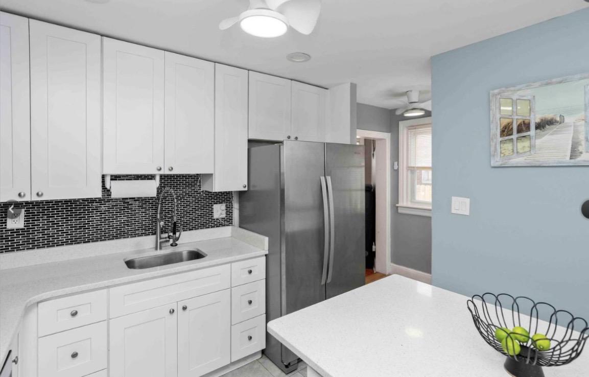 914 Township Line Road Elkins Park, PA 19027 - Photo 9 of 22 a kitchen with a sink refrigerator and cabinets