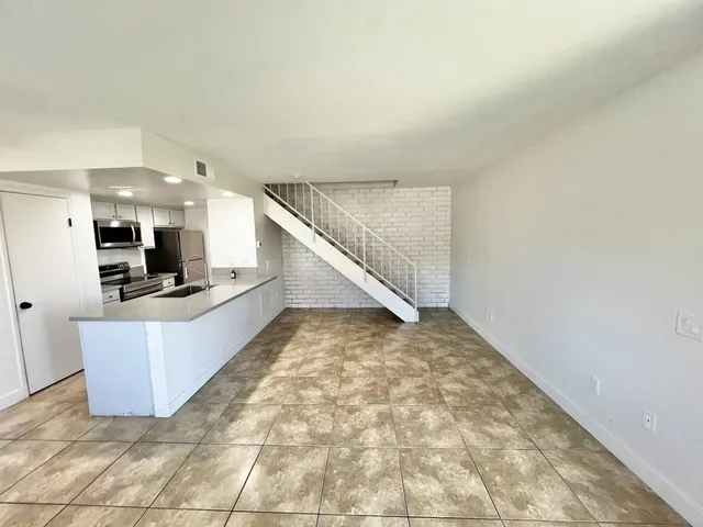 a view of kitchen with microwave and cabinets