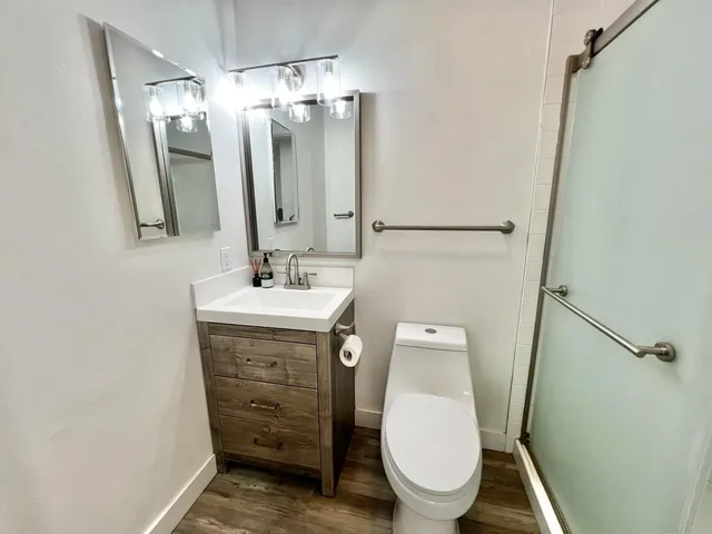 a bathroom with a toilet a sink and mirror