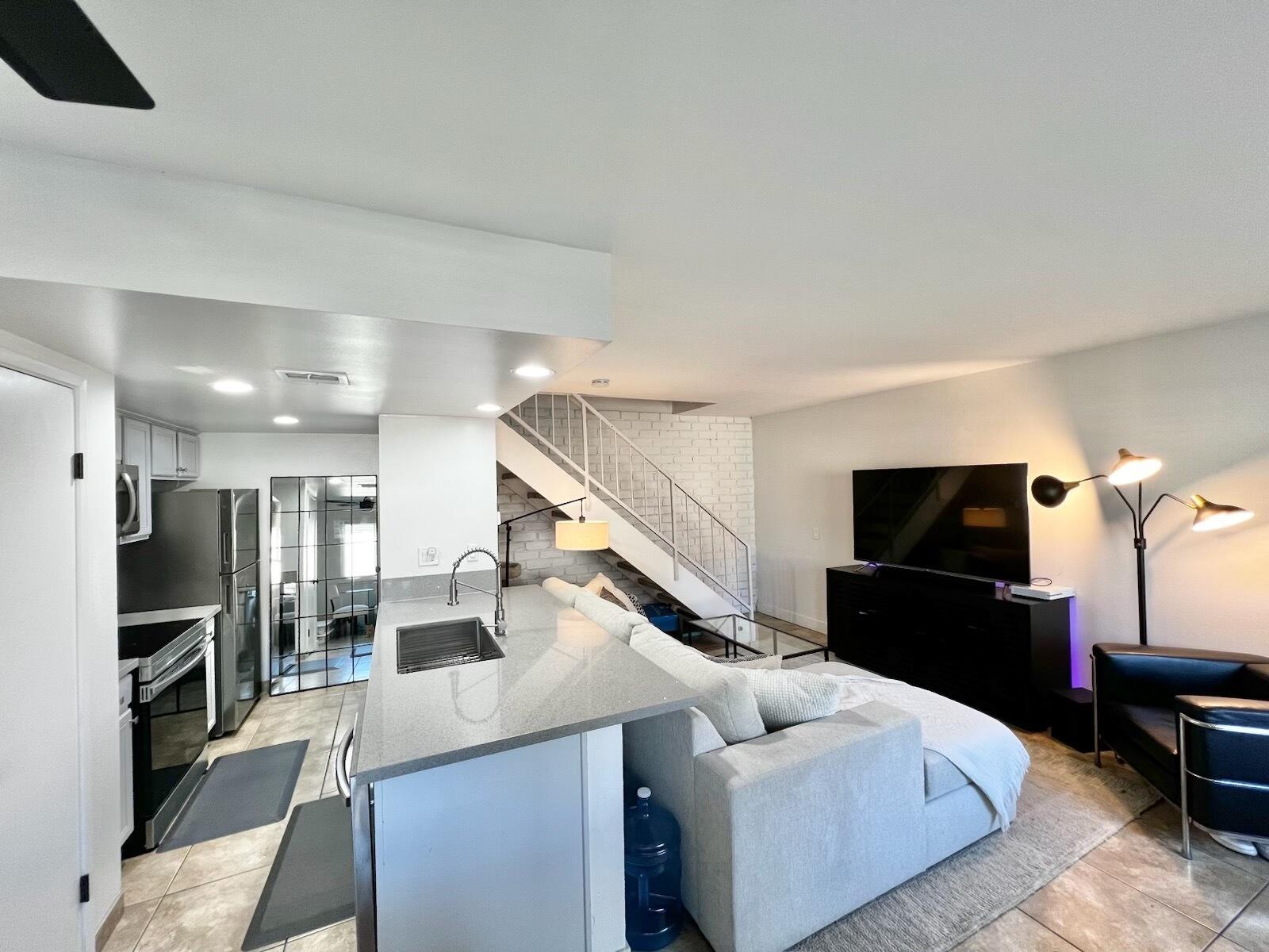 72671 Eagle Road, Unit 3 Palm Desert, CA 92260 - Photo 6 of 25 a living room with furniture and a flat screen tv