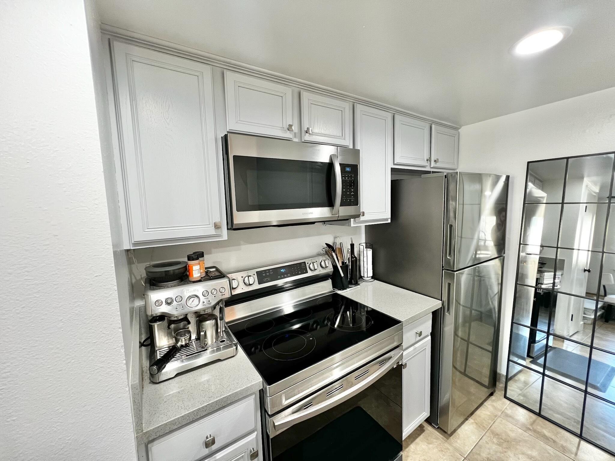 72671 Eagle Road, Unit 3 Palm Desert, CA 92260 - Photo 7 of 25 a kitchen with a refrigerator stove and microwave