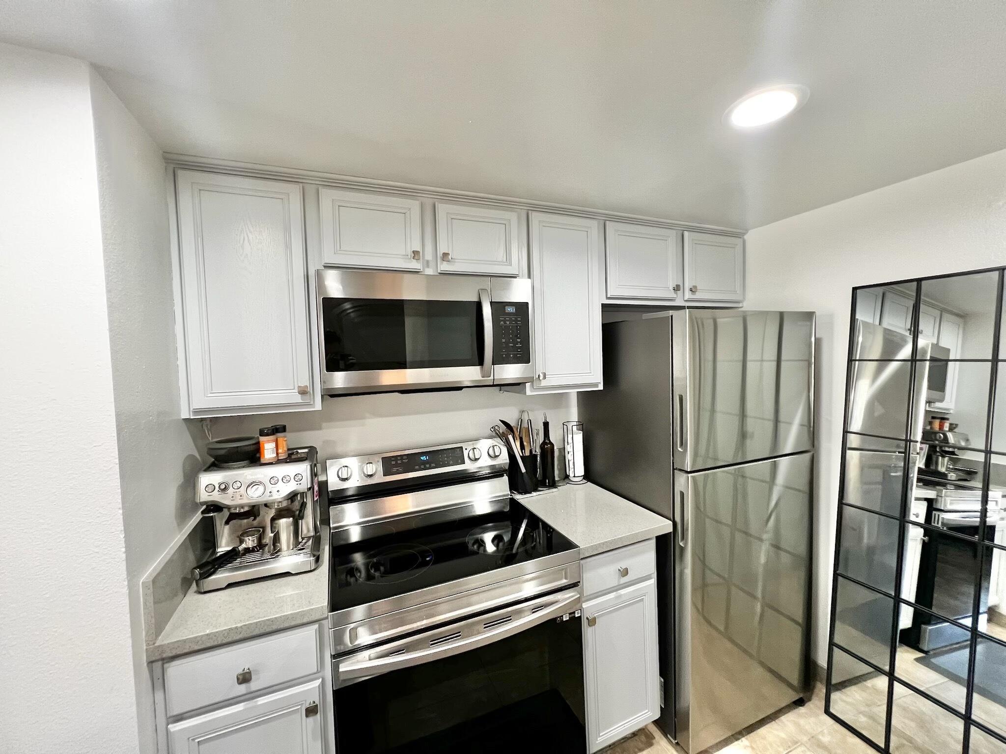 72671 Eagle Road, Unit 3 Palm Desert, CA 92260 - Photo 8 of 25 a kitchen with a refrigerator stove and microwave