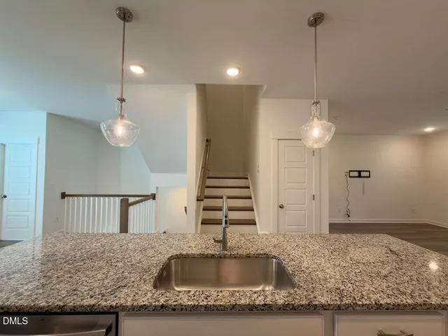 a kitchen with sink stove and microwave