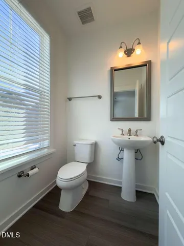 a view of an empty room and wooden floor
