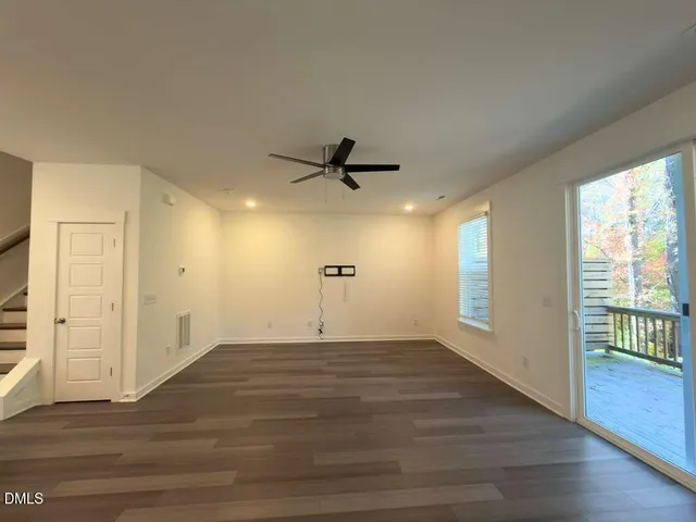 a balcony with wooden floor and trees