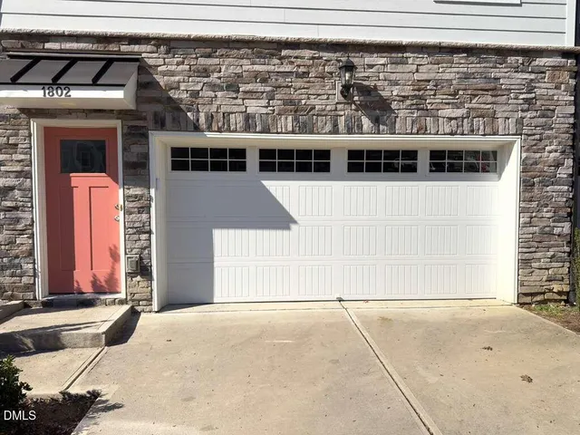 a kitchen with kitchen island granite countertop a refrigerator and a sink