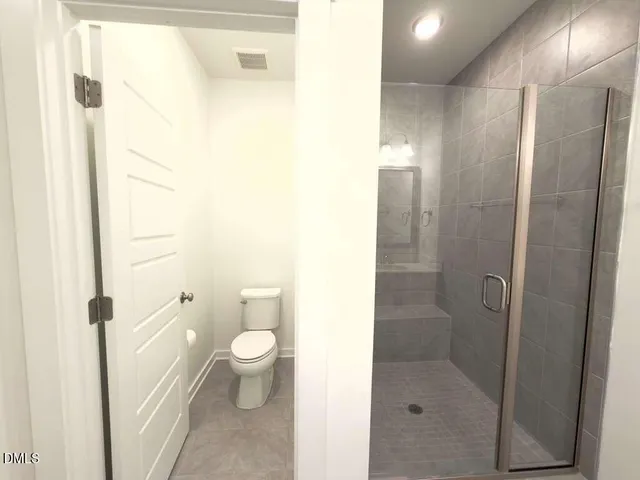 a bathroom with a sink a toilet and a large mirror