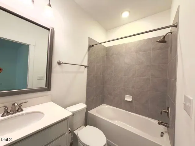 a yellow house with trees in front of it