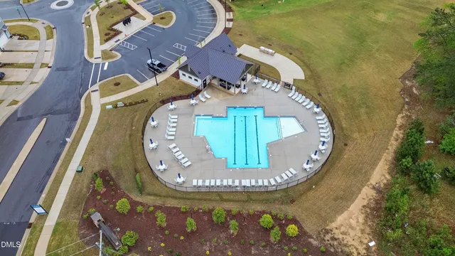 an aerial view of a house with garden space lake view and mountain view in back