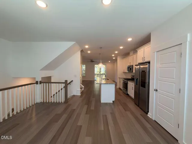 a view of a kitchen with a sink and refrigerator