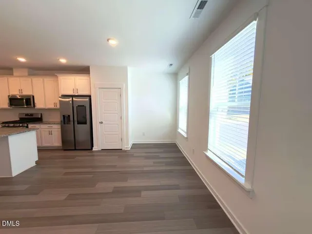 a kitchen with refrigerator a sink and cabinets