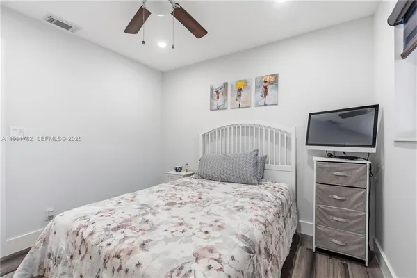 a bedroom with a bed and a tv