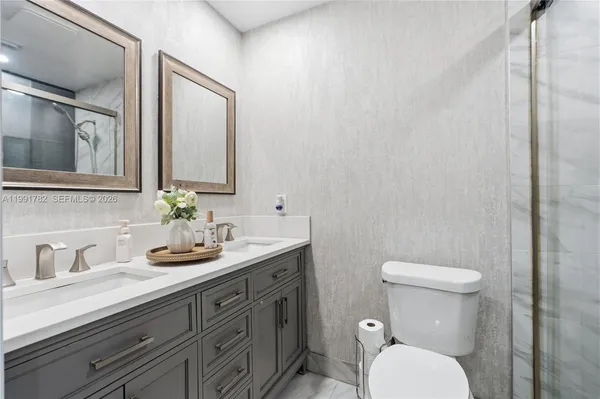 a bathroom with a toilet sink and mirror