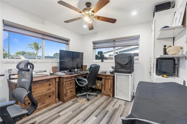 a view of a workspace with furniture and a window
