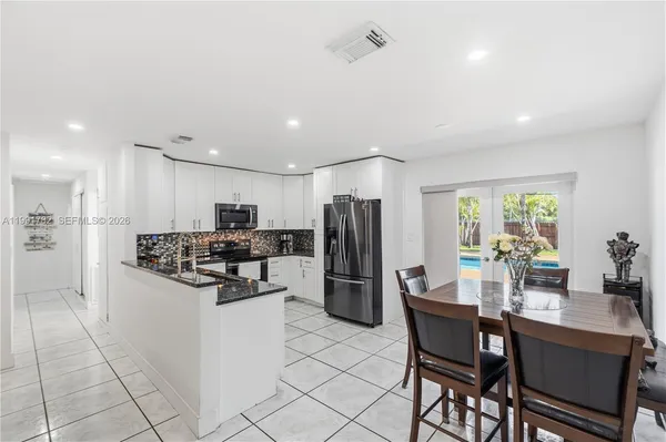a kitchen with refrigerator and cabinets