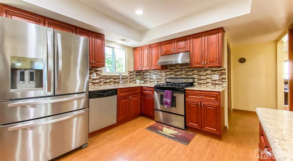 0 Lavender Drive Edison, NJ 08820 - Photo 17 of 36 a kitchen with stainless steel appliances granite countertop a refrigerator and wooden cabinets