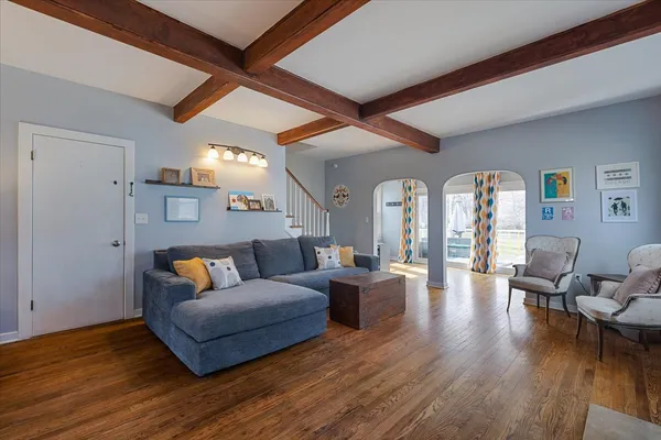 a living room with furniture and wooden floor