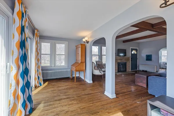 a view of an entryway with wooden floor and a livingroom