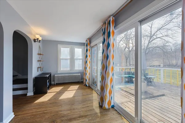 a view of entryway with wooden floor and door